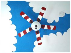 a ceiling fan made to look like a cat in the hat with red and white stripes