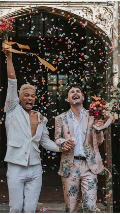 two men standing in front of a doorway with confetti