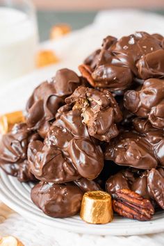 a white plate topped with chocolate covered pretzels and pecans