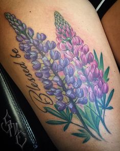 a woman's thigh with flowers on it and the words, love is in bloom