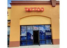 a store front with the words tattoo on it's side and two doors open