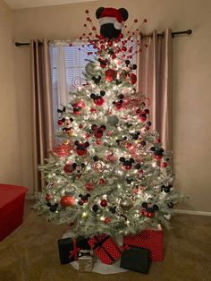 a white christmas tree with mickey mouse decorations