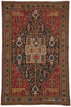 an antique persian rug with various colors and designs on the border, including red, blue,