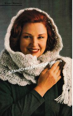 a woman wearing a white knitted hood and scarf with her hands on her chest