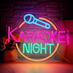 a neon sign that says karaoke night in front of a brick wall and potted plant