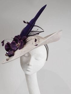 READY MADE FOR DISPATCH A silver grey disc style hat, trimmed with aubergine orchid flowers in tone feathers and sinamay loops. Delivery to USA via courier transit time 3-5 days Elegant Gray Felt Hat With Short Brim, Elegant Gray Brimmed Felt Hat, Elegant Gray Wide Brim Felt Hat, Silver Fascinator For Kentucky Derby Races, Elegant Gray Felt Hat With Curved Brim, Party Felt Hat With Curved Brim, Silver Brimmed Party Hat, Elegant Silver Hat For Kentucky Derby, Silver Fitted Mini Hat For Kentucky Derby