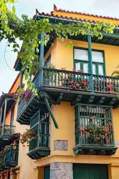 an apartment building with balconies and flower boxes on the upper floor, along with balcony railings