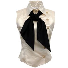 Chanel Ivory Silk Sleeveless Blouse With Black Tie Neck Condition: Very Good Condition Fabric Content: 100% Silk Care: Dry Clean Country Of Origin: France Color: Ecru Closure / Opening: Front Buttons Size Us 8 / Fr 40 (Runs Small, See Measurements) Bust 18.25" Waist 15.5" Hip 16.25" Length 19" Material: Silk Category: Clothing Subcategory: Tops Sub Sub Category: Blouses 30274-11 S1024ma ** Photos Are Of The Actual Item ** ** Roundabout Couture Certified Authentic ** Saint Laurent Blouse, Classic Sleeveless Formal Blouse, Designer Sleeveless Tops For Evening, White Formal Sleeveless Top, Cream Sleeveless Formal Top, Designer Sleeveless Silk Top, Cream Sleeveless Top For Formal Occasions, Designer Silk Sleeveless Tops, Elegant Fitted Silk Vest