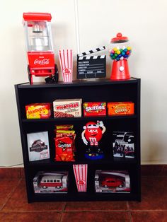 a shelf filled with different types of toys and candy on top of eachother