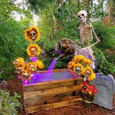 skeletons and sunflowers decorate an outdoor fountain for the day of the dead celebration