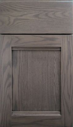 a wooden cabinet door with a square knob on the front and side panel in dark wood