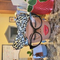 a pair of eyeglasses are hanging on the wall next to a potted plant