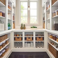 an organized pantry with lots of shelves and baskets