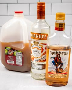 the ingredients to make an apple cider are shown in front of a white tile wall