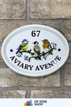 a sign on the side of a brick wall that says'77 aviary avenue '