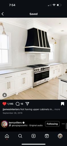 an image of a kitchen with white cabinets and black stove top oven in the middle