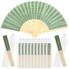 a green and white hand fan with six pieces of bamboo sticks next to each other