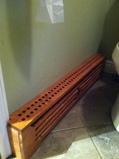 a wooden bench next to a toilet in a bathroom