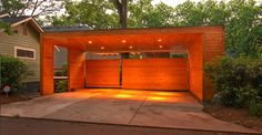 an open garage with lights on the side and trees in the backgrouund