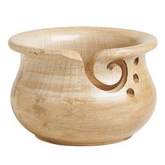 a wooden bowl with an intricate design on the inside and outside, sitting on a white background