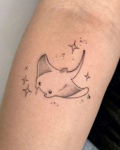 a tattoo on the arm of a woman with stars and an animal's head