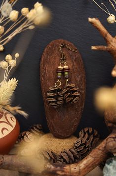 Nature jewelry lovers watch out! The forest jewelry collection is expanded with new redwood cone earrings. These beautiful wooden earrings are equipped with real redwood cones from the Black Forest in southern Germany and delight every nature lover. The handmade wooden jewelry pieces are a perfect gift for the nature jewelry lover. Each earring has been carefully crafted from natural materials and is therefore unique. Wear a piece of the forest on your ears with a pair of fir earrings and show your love for nature. These nature earrings are versatile enough to be worn with a variety of outfits. Explore our collection of redwood earrings and wooden jewelry and find the piece of jewelry that enhances your personality. Treat yourself or a loved one to something special that is guaranteed to m Druid Jewelry, Handmade Rustic Jewelry For Outdoor, Eastern Woodlands, Nature Earrings, Hippie Earrings, Earring Tree, Wooden Earrings, Bead Stringing, Wooden Jewelry