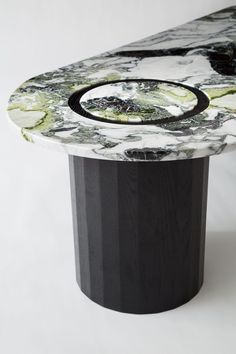 a black and white marble table with a circular design on it