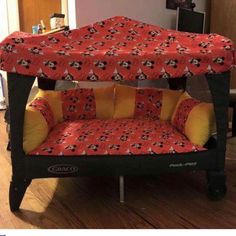 a red and black chair with mickey mouse on it