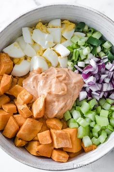 a bowl filled with chopped vegetables and dressing