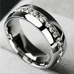 a wedding ring with white diamonds on the inside and inlays to make it stand out