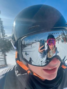 a person wearing ski goggles taking a selfie