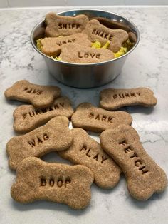 personalized dog treats are shown in front of a metal bowl