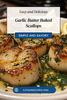 garlic butter baked scallops on a plate with lemon wedges