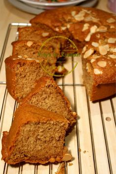 sliced loaf of banana bread sitting on top of a cooling rack next to a plate