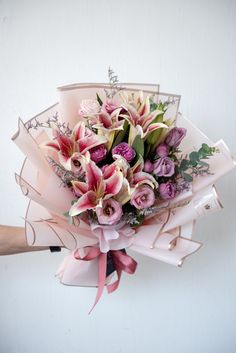 a bouquet of flowers is being held by someone