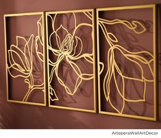 three metal wall art panels with flowers on them