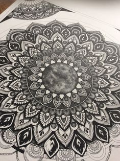 an intricate black and white drawing on paper