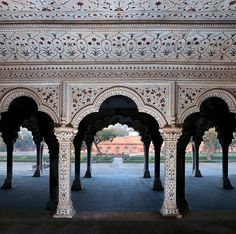 an intricately decorated building with arches and pillars