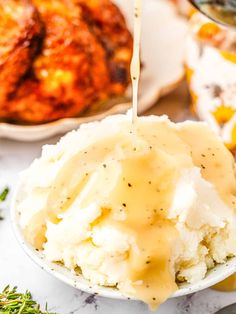 mashed potatoes being drizzled with gravy