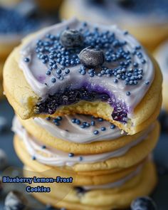 blueberry lemon frosted cookies stacked on top of each other