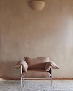 a chair sitting on top of a rug next to a wall