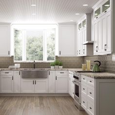 a large kitchen with white cabinets and wood flooring is pictured in this image, it appears to be empty