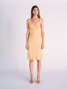 Silk Tied Shoulder Dress in Cantaloupe/Peach colorLuxurious silk dress with tied shoulder detail and invisible zipper detail in back.  V neckline with gathered bust on bodice.Also comes in custom colors.  Please message to inquire about custom dresses.COMPOSITION-100% silk Apricot Sleeveless Evening Dress, Elegant Apricot Evening Dress, Elegant Apricot V-neck Dress, Apricot Evening Dress For Summer, Elegant Sleeveless Apricot Midi Dress, Elegant Apricot Midi Length Dress, Feminine Sleeveless Silk Satin Dress, Spring Silk Dress Bias Cut, Elegant Peach Midi Dress For Evening