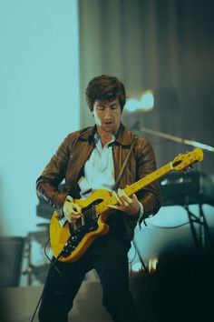 a man playing an electric guitar on stage