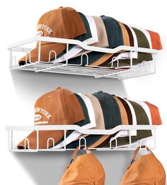 two white shelves with hats hanging on them