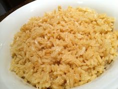 a white bowl filled with rice on top of a table