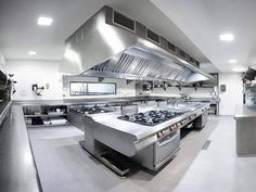 an industrial kitchen with stainless steel appliances and counters