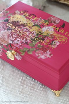 a pink box with flowers painted on it