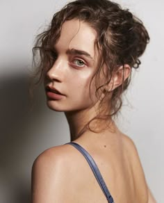 a woman with wet hair and blue bra