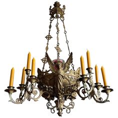 an antique chandelier with six candles hanging from it's arms and wings